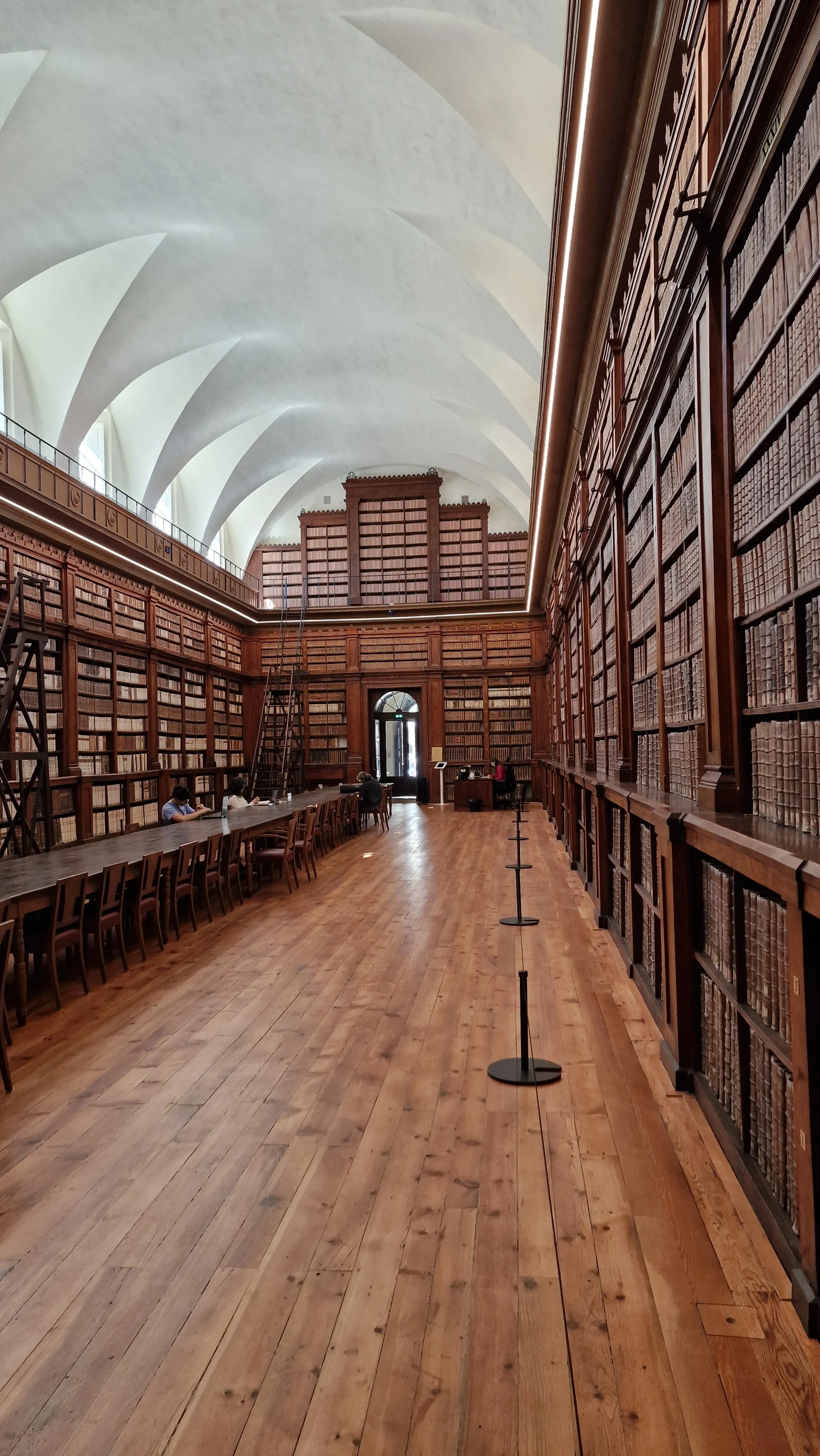 Interior view of a traditional wooden building with curved walls and exposed beam ceiling